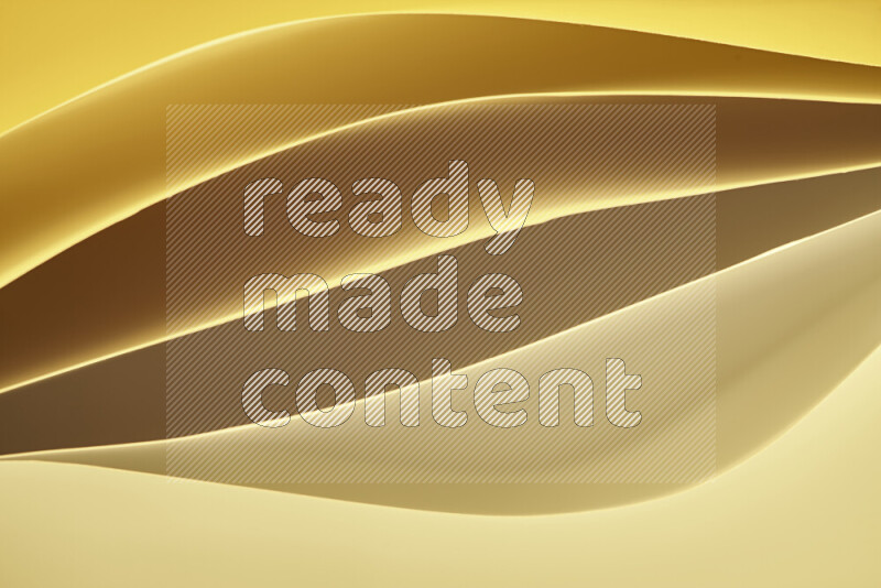 This image showcases an abstract paper art composition with paper curves in gold gradients created by colored light