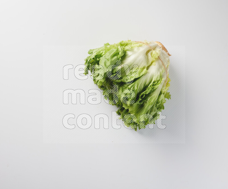 A fresh head of lettuce with green leaves on white background