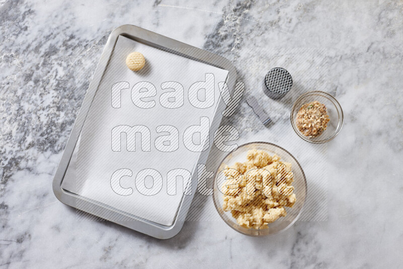 Kahk step by step with its ingredients ghee, sugar, flour, sesame, yeast, water and kahk flavor on grey marble background