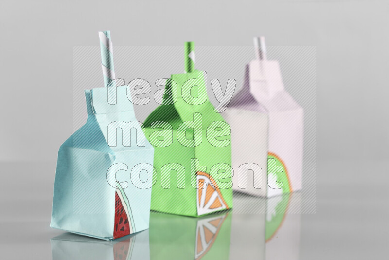 Origami juice box on grey background