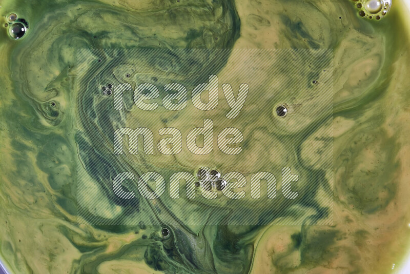 A close-up of abstract swirling patterns in orange and green