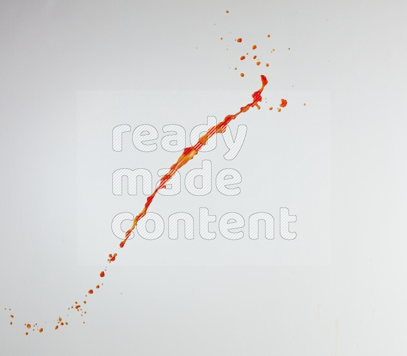 Orange liquid splash and drops on white background