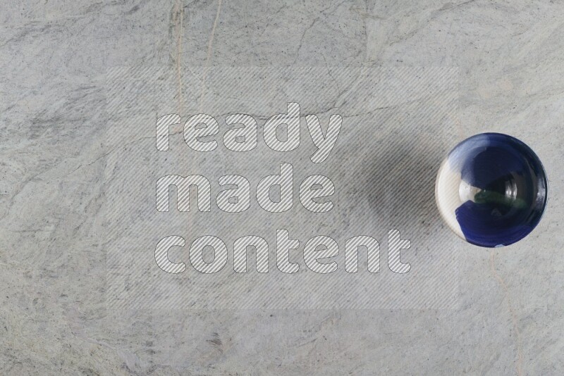 A multicolored pottery Bowl on grey marble background