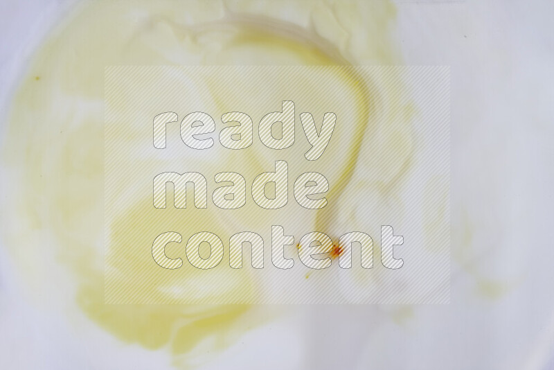 A close-up of abstract swirling patterns in yellow and white