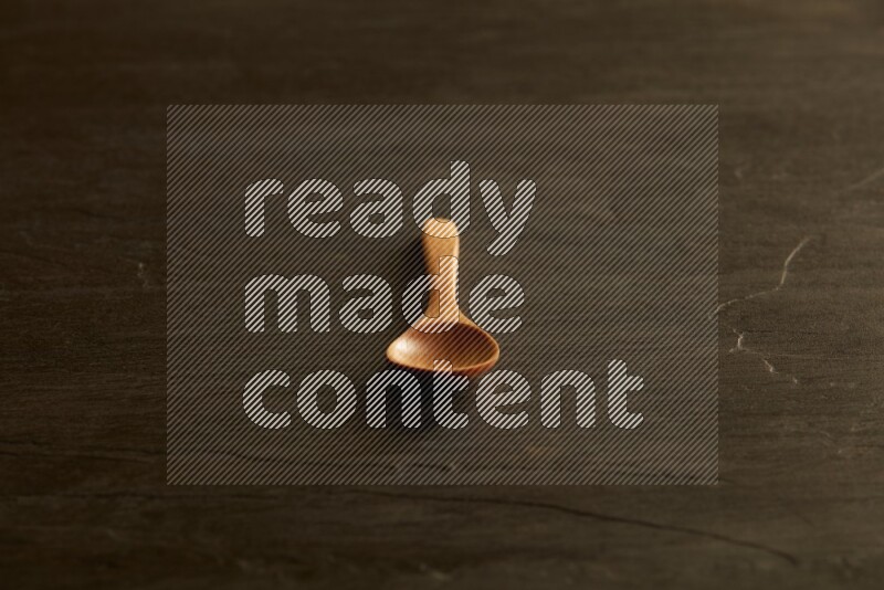 wooden spoon on black slate background