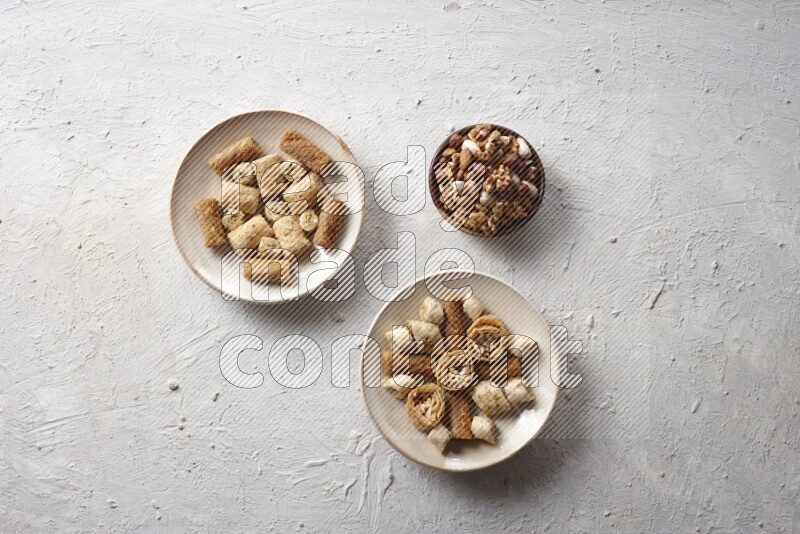 Oriental sweets in pottery plates with nuts in a light setup