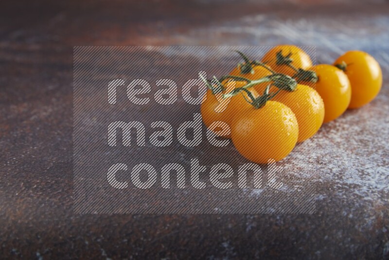 Yellow cherry tomato vein on reddish rustic metal background 45 degree