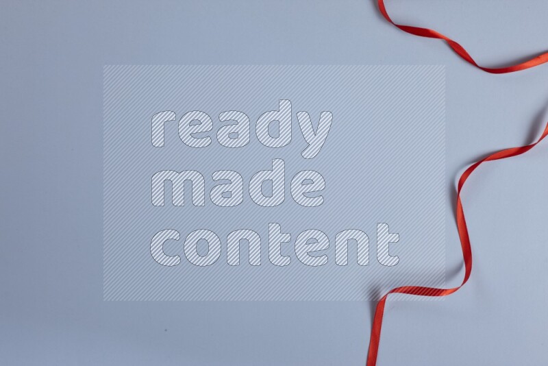 A red collection of sewing and tailoring tools arranged on a blue background