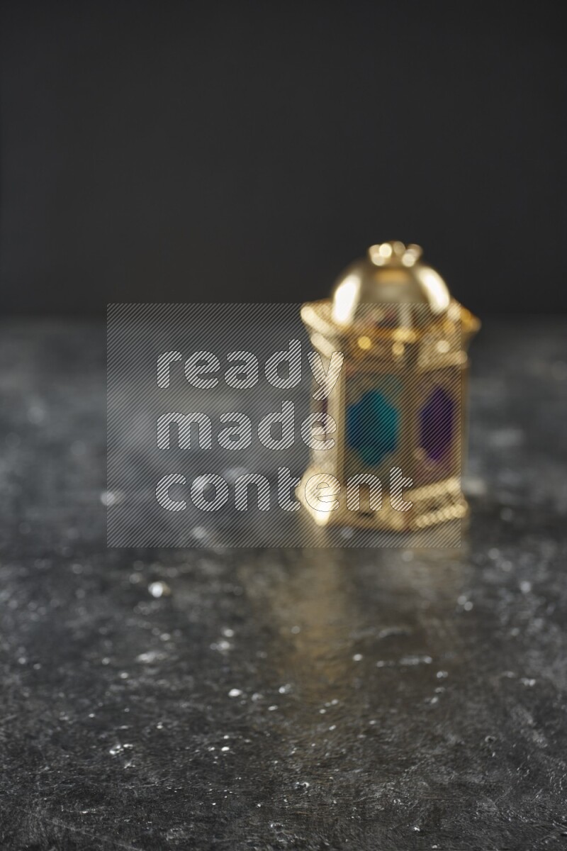 An out of focus lantern on textured black background