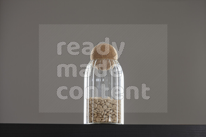 Lupin Beans in a glass jar on black background