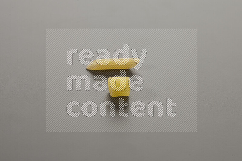 Big rings pasta with other types of pasta on grey background