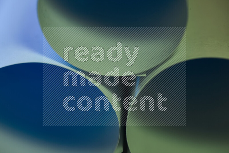 The image shows an abstract paper art with circular shapes in varying shades of green and blue