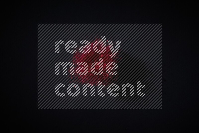 Red powder explosion on black background