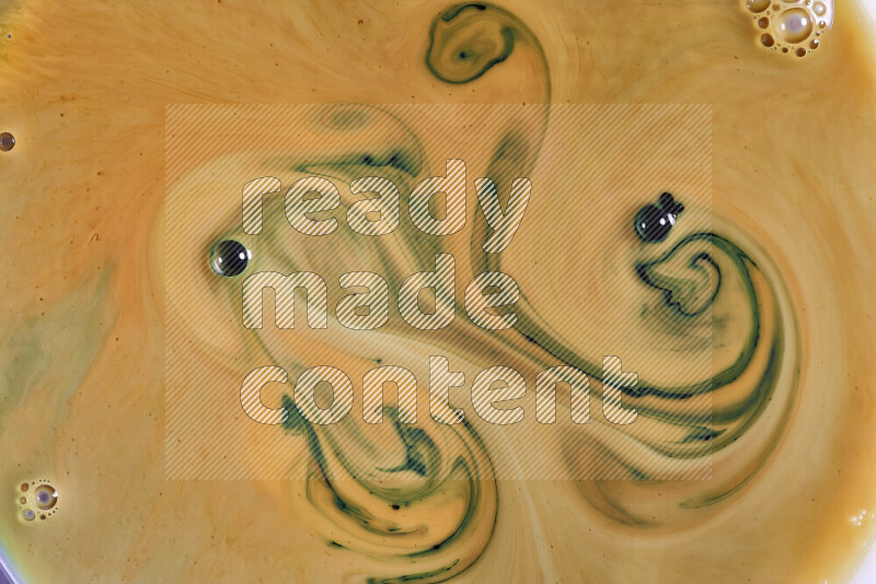 A close-up of abstract swirling patterns in orange and green