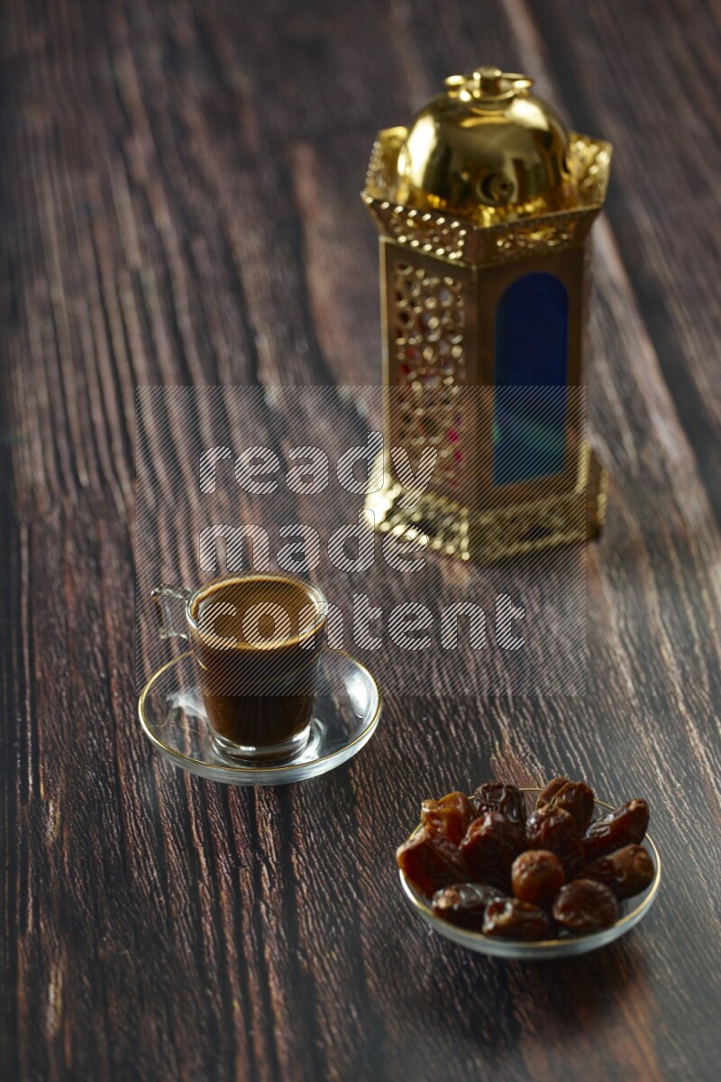 A golden lantern with different drinks, dates, nuts, prayer beads and quran on brown wooden background