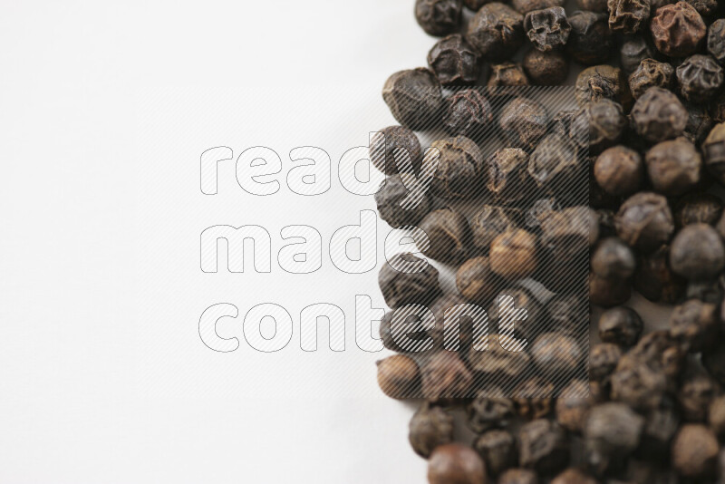 Black pepper beads on white background