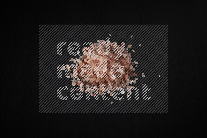 A bunch of coarse himalayan salt crystals on black background