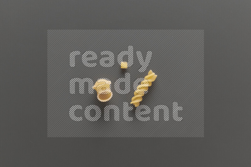 Different pasta types on grey background