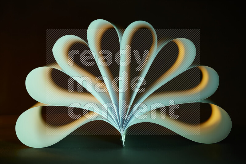 An abstract art piece displaying smooth curves in yellow and green gradients created by colored light