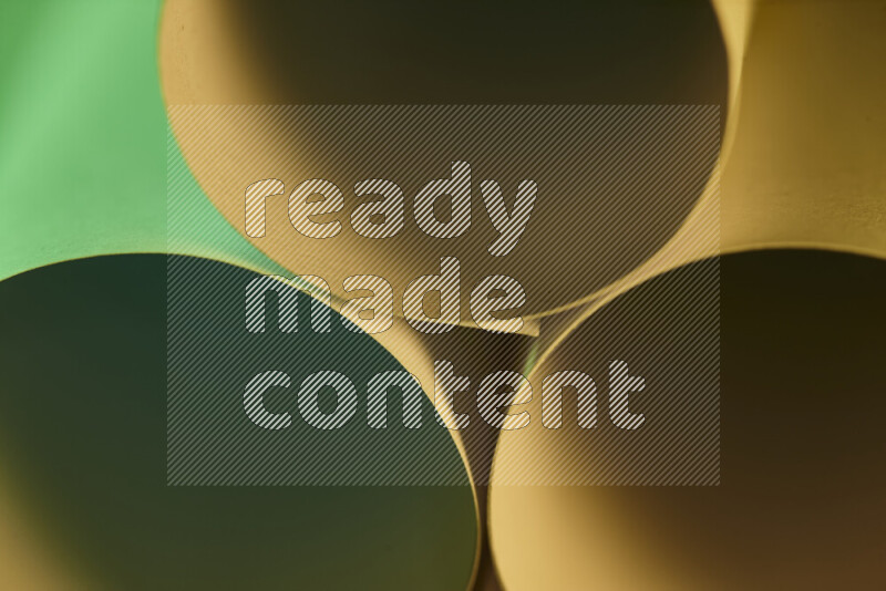 The image shows an abstract paper art with circular shapes in varying shades of green and warm tones