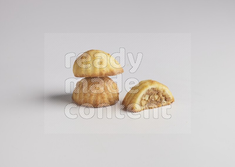Three Pieces of Maamoul filled with walnut paste  one of them is cut direct on white background