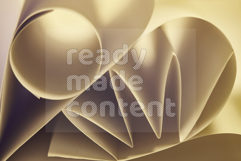 An artistic display of paper folds creating a harmonious blend of geometric shapes, highlighted by soft lighting in warm tones