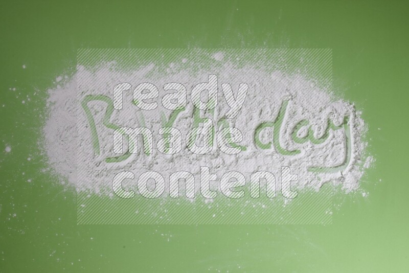 A word written with white powder on green background