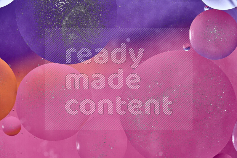 Close-ups of abstract oil bubbles on water surface in shades of purple, orange and pink