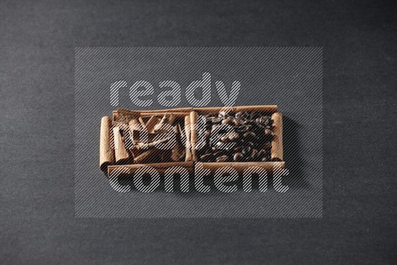 2 squares of cinnamon sticks full of coffee beans and cinnamon on black flooring