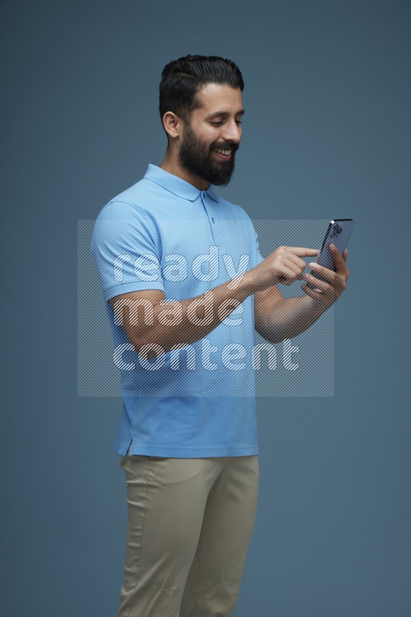 A man Swiping in a blue background wearing a Blue shirt
