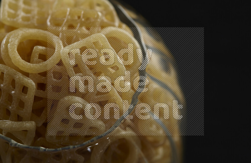 Snacks in a glass jar on black background