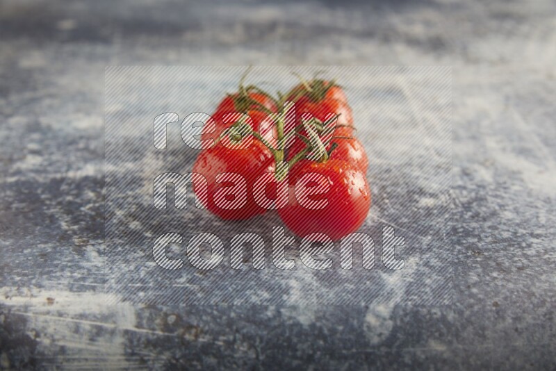 Red cherry tomato vein on a textured rusty blue background 45 degree