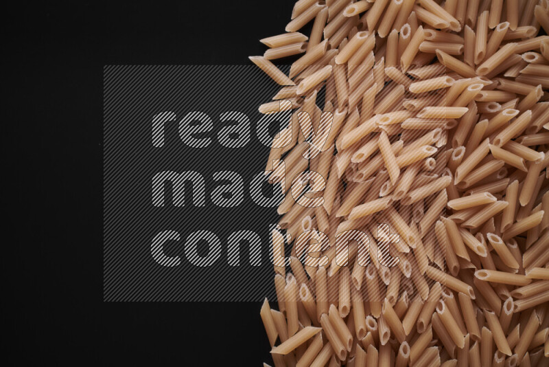 Different pasta types on black background