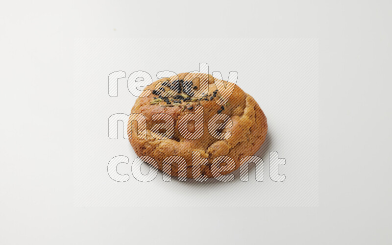 Hasawi cookie field with date and decorated by black seed and Anise grain on a white background