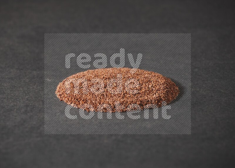 Garden cress seeds in a circle shape on a black flooring