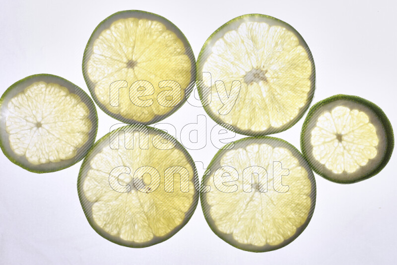 Orange slices on illuminated white background