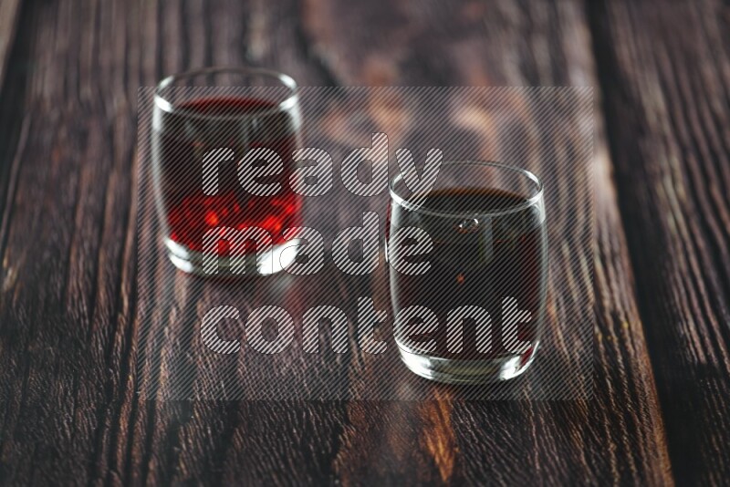 Cold drinks in a glass cup such as water, tamarind, qamar eldin, sobia, milk and hibiscus on wooden background