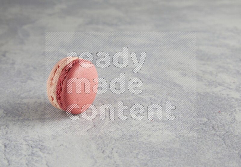 45º Shot of Pink Litchi Raspberry macaron on white  marble background