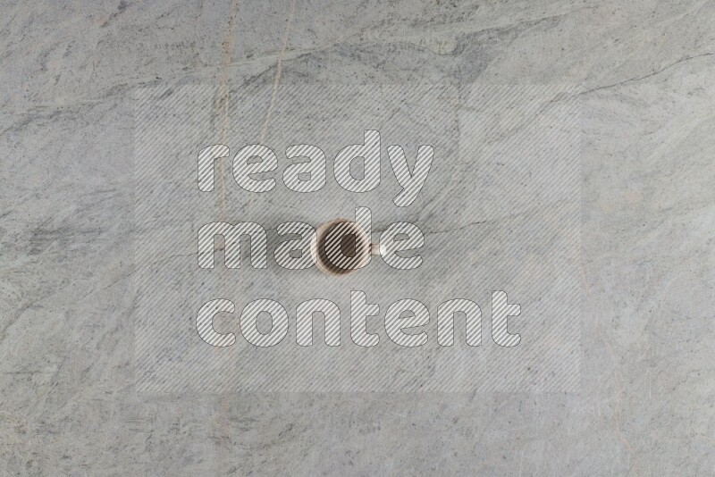 A multicolored pottery Cup on grey marble background