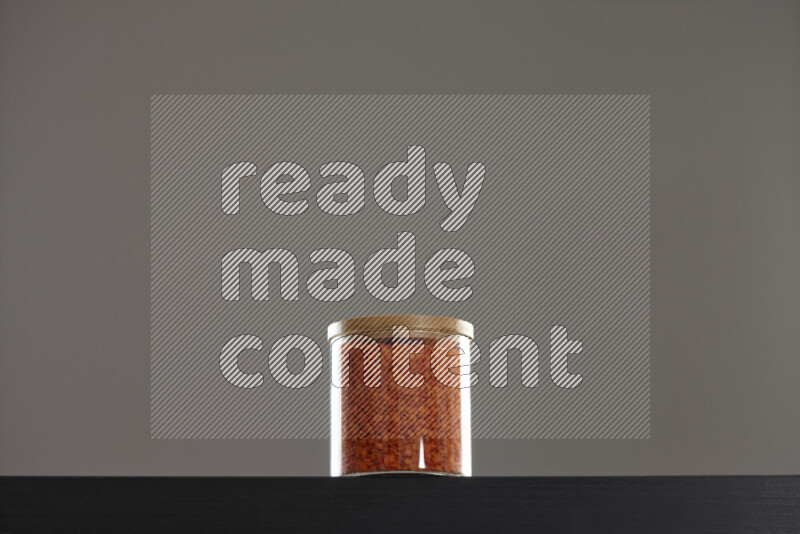 Lentils in a glass jar on black background