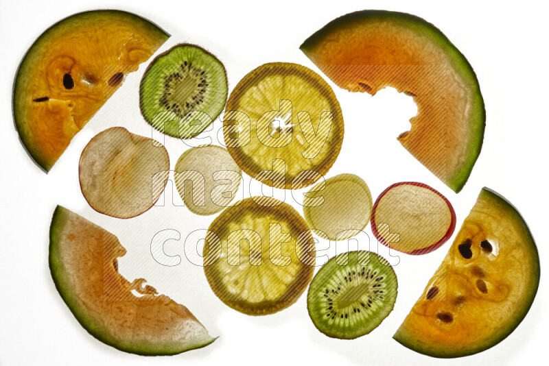 Mixed fruits slices on illuminated white background