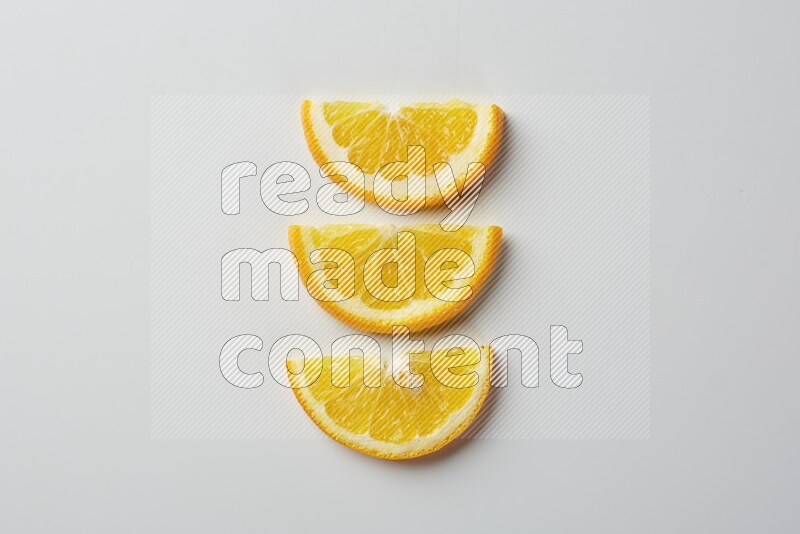 Three halves of an orange slices on white background