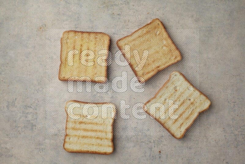Toasted white Toast slices on a light blue textured background