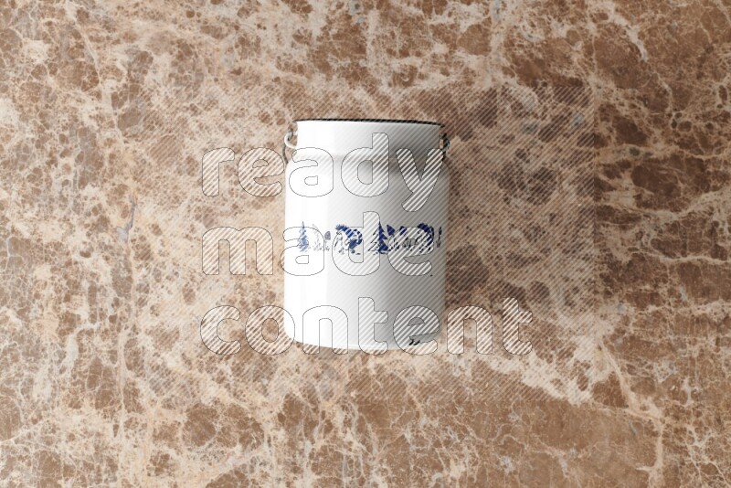 A vintage milk can on beige marble background