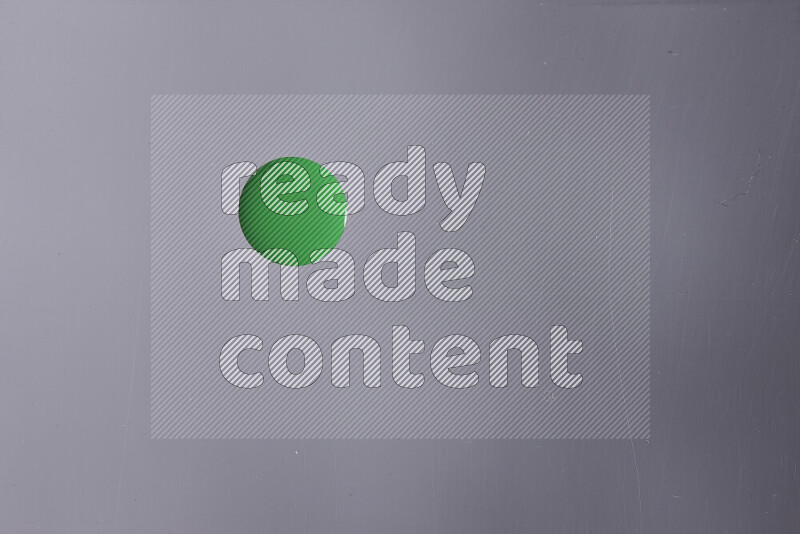 Close-ups of abstract green paint droplets on the surface