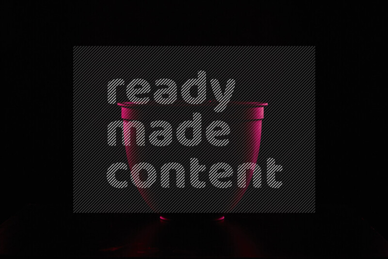 A reflector diffuser lamp shade dish with colored rim light against black background