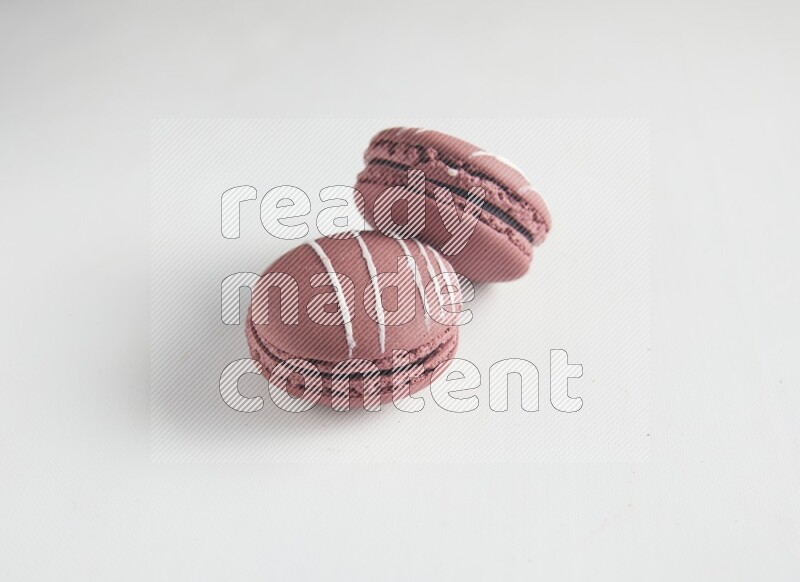 45º Shot of two Red Poppy Flower macarons on white background