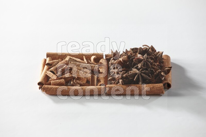 2 squares of cinnamon sticks full of star anise and cinnamon on white flooring