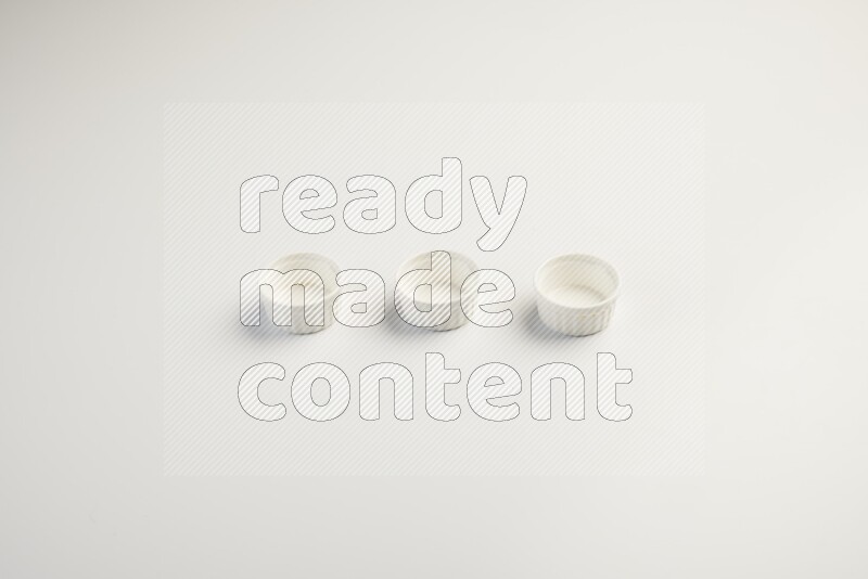 white ceramic round sauce dish on white countertop