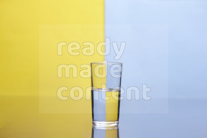 The image features a clear glassware filled with water, set against yellow and light blue background